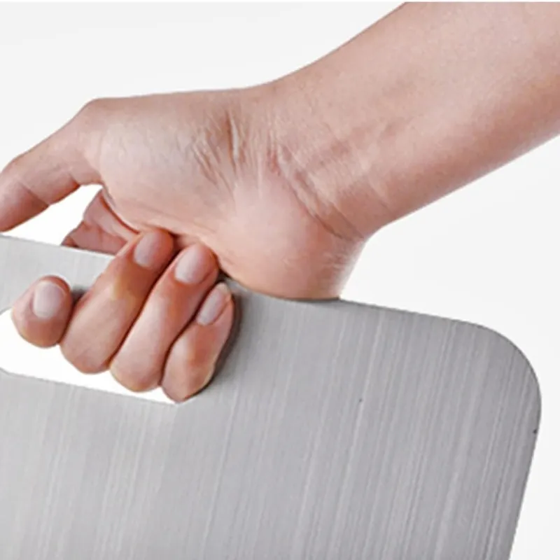 The Barechop titanium board lifted by its handle slot, showing the slim brushed sheet